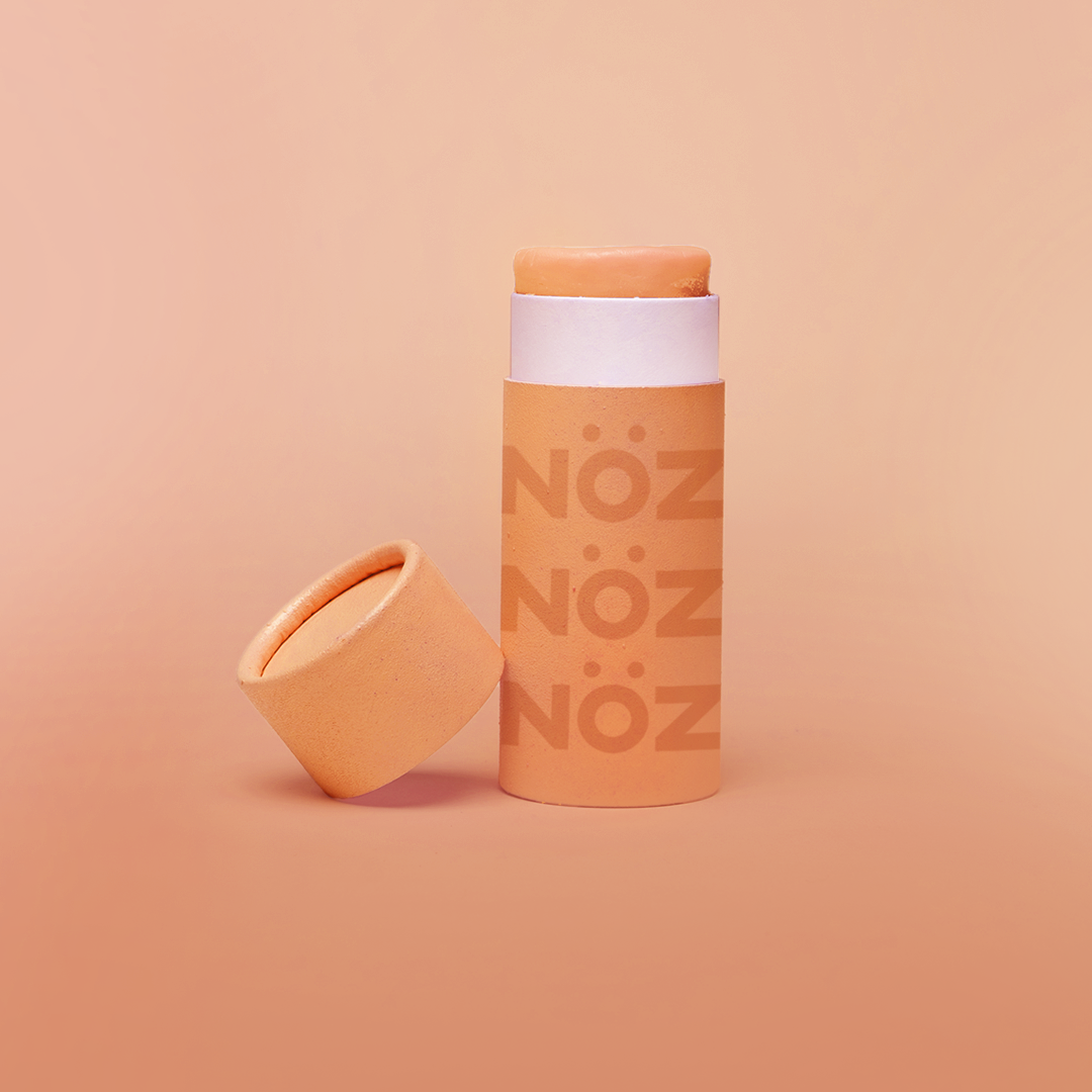 Nöz’s reef safe, Zinc oxide, & colorful sunscreen in orange.